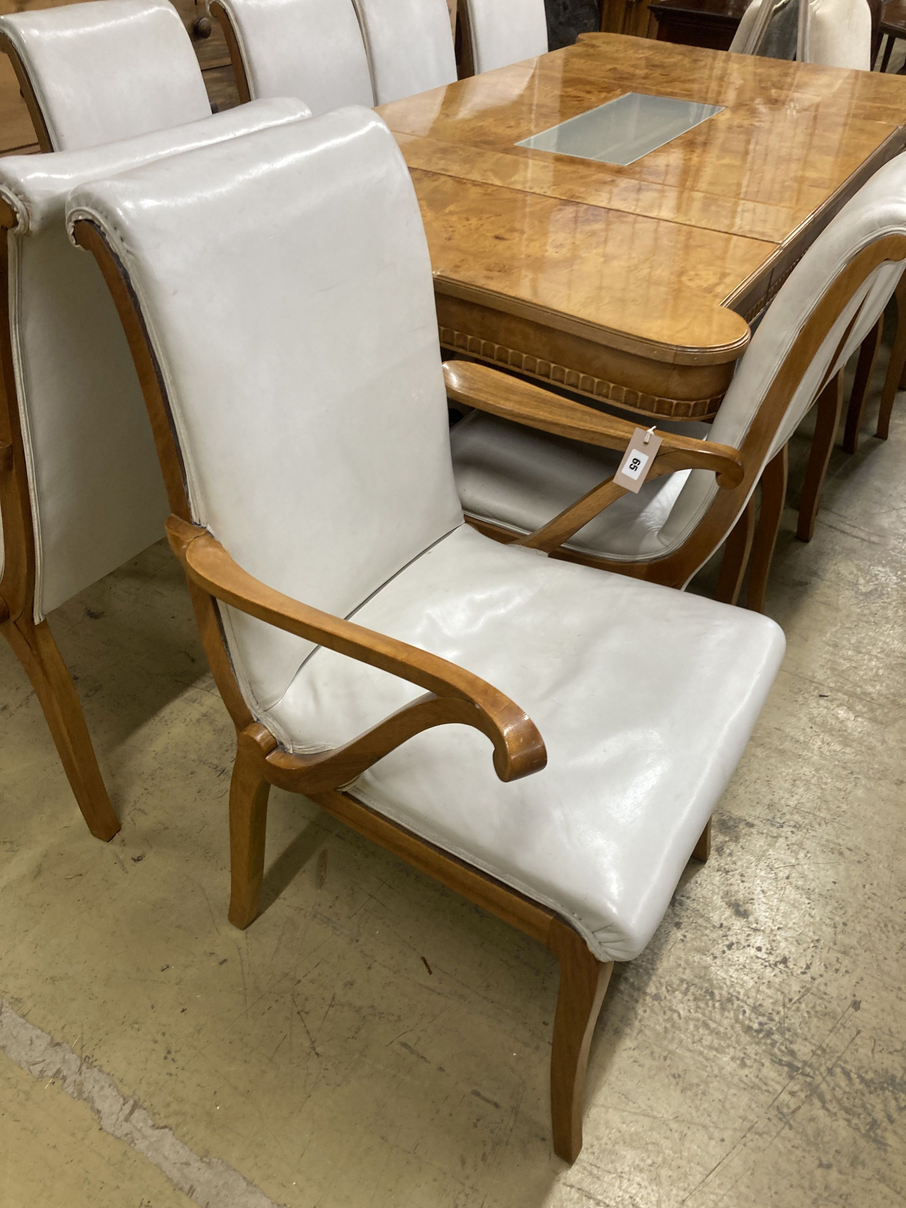 A mid century birds eye maple and walnut dining suite, comprising extending table, 205cm, depth 106cm, height 76cm, a set of ten dining